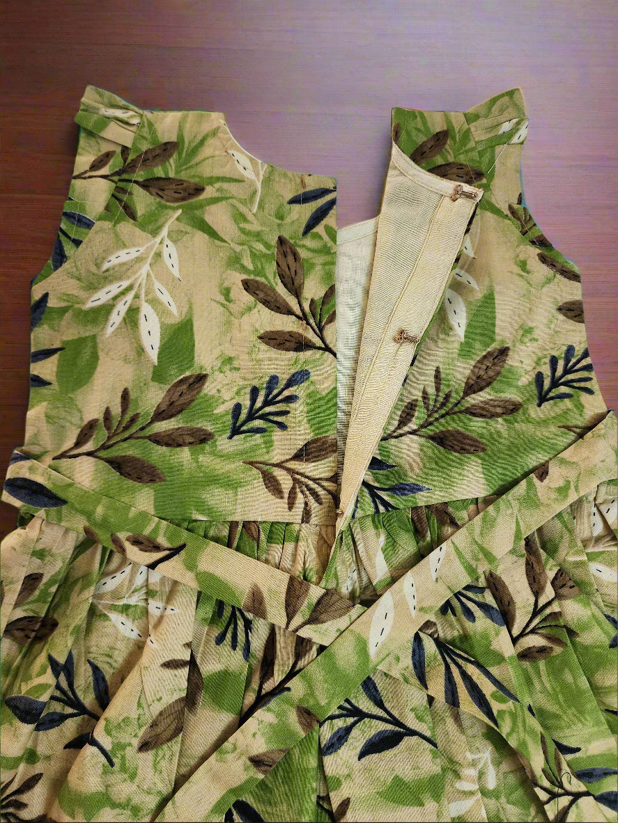 Fabric with green and brown leaf pattern on a wooden surface