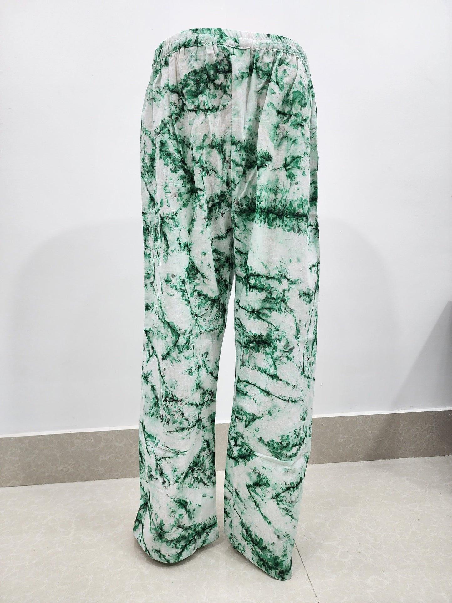 Green and white patterned pants on a white background