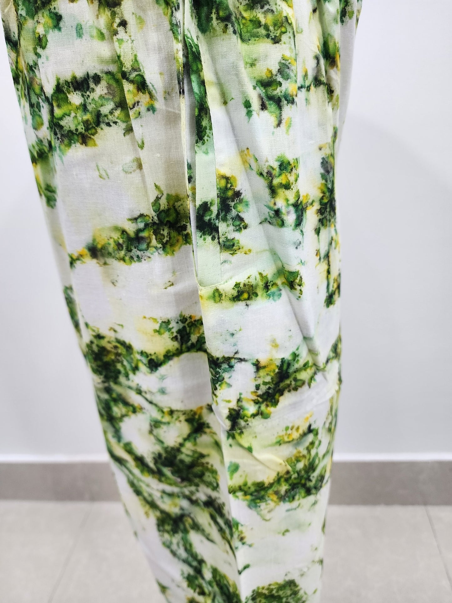 Green and white patterned fabric on a plain background