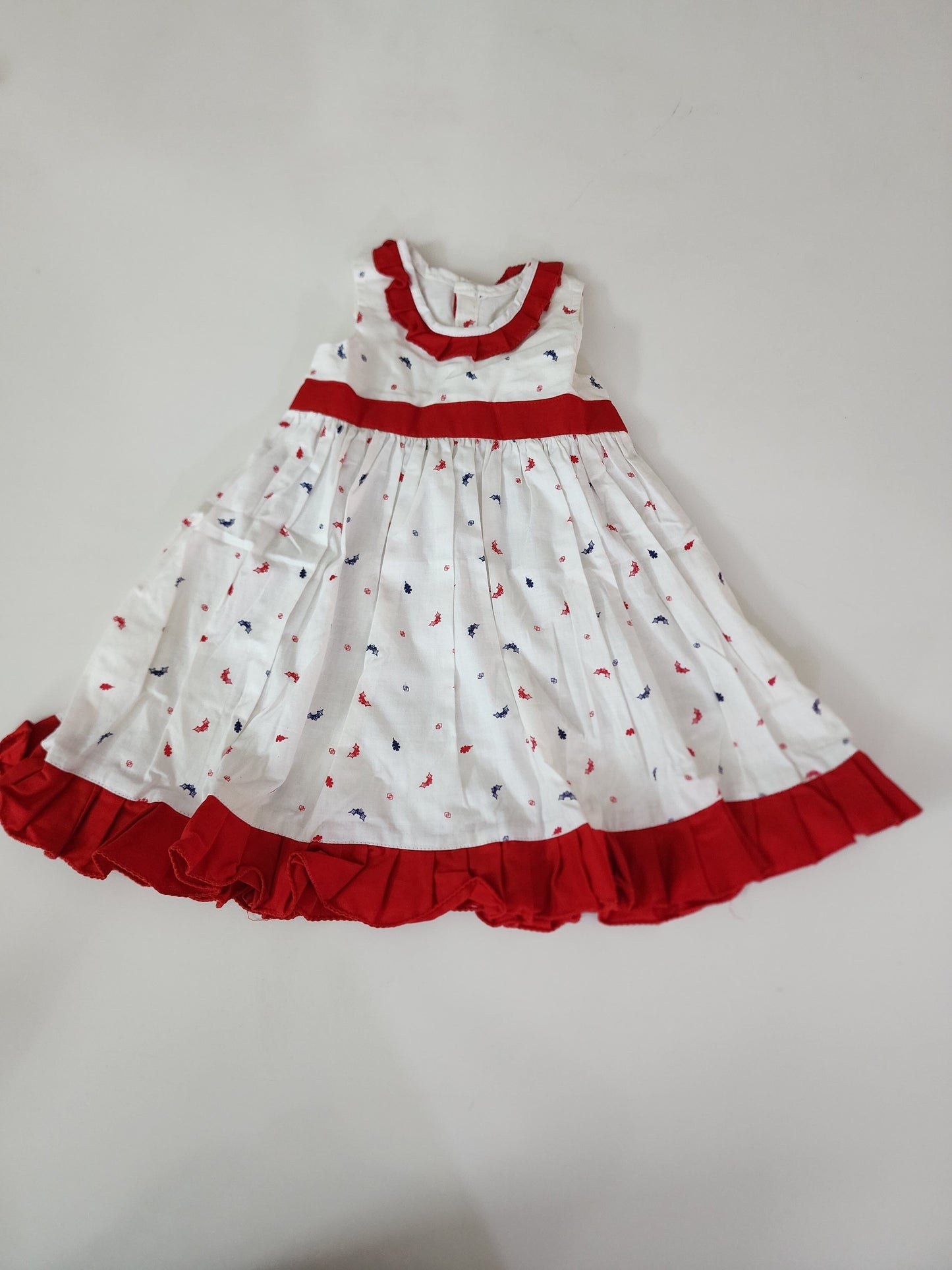 A lovely white cotton frock with a charming print and red lace