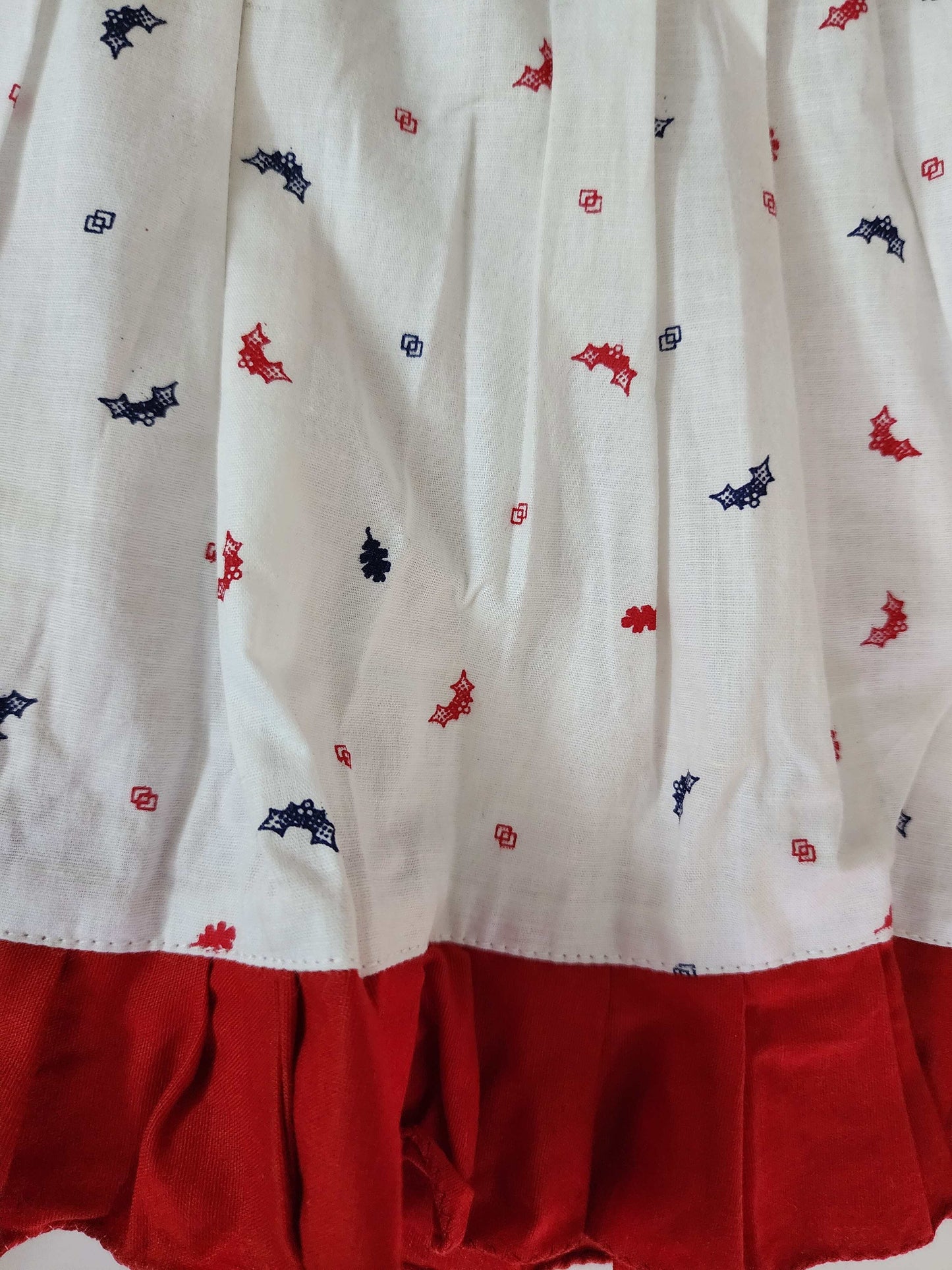 A lovely white cotton frock with a charming print and red lace
