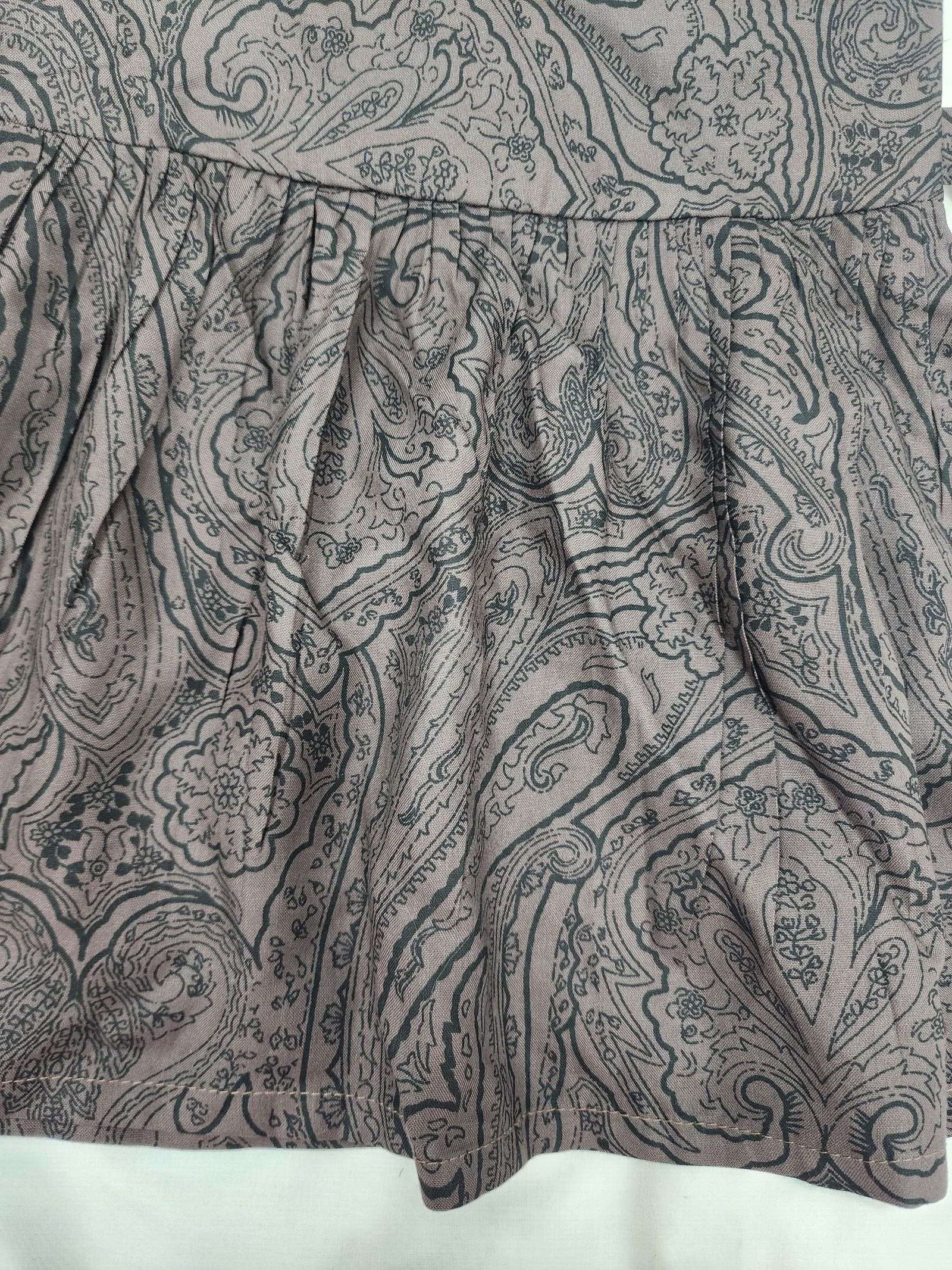 Close-up of a patterned fabric with paisley design on a white background