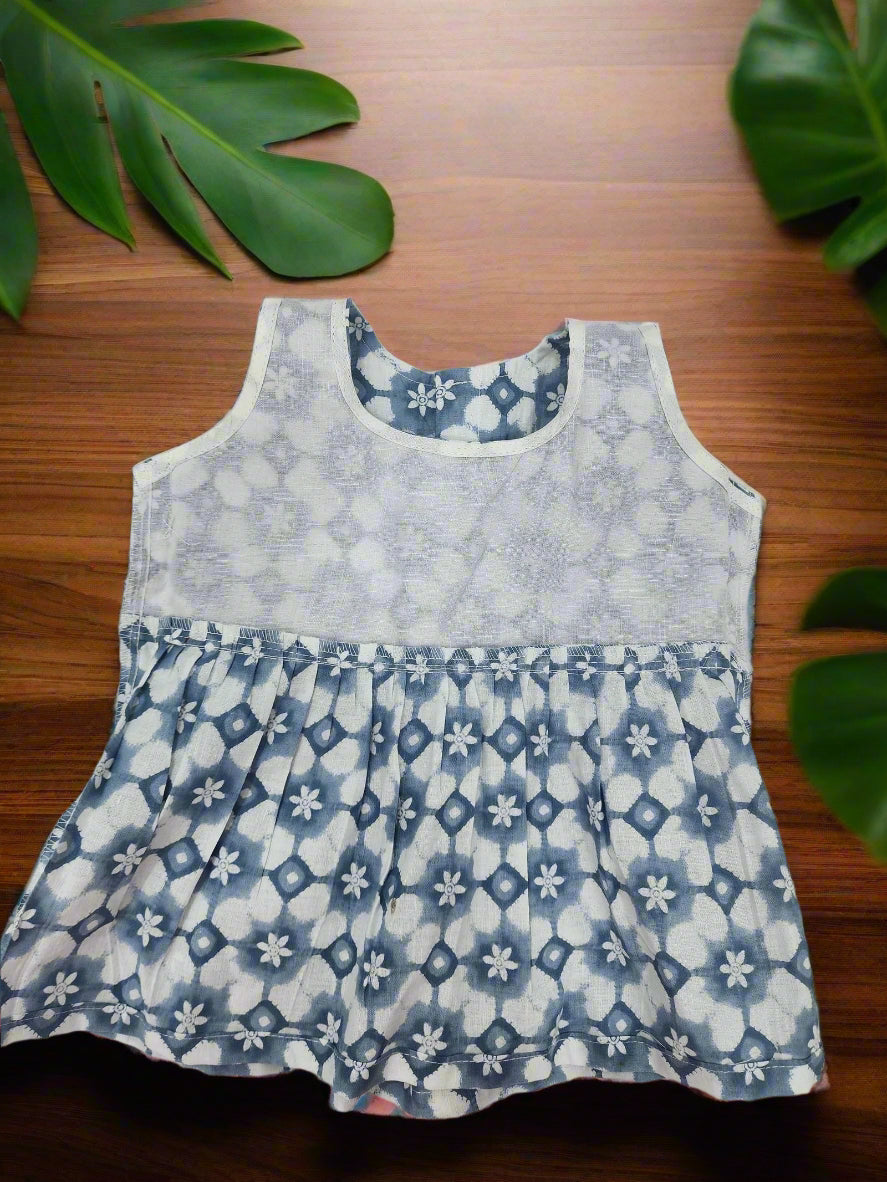 Blue and white patterned dress on a light gray background