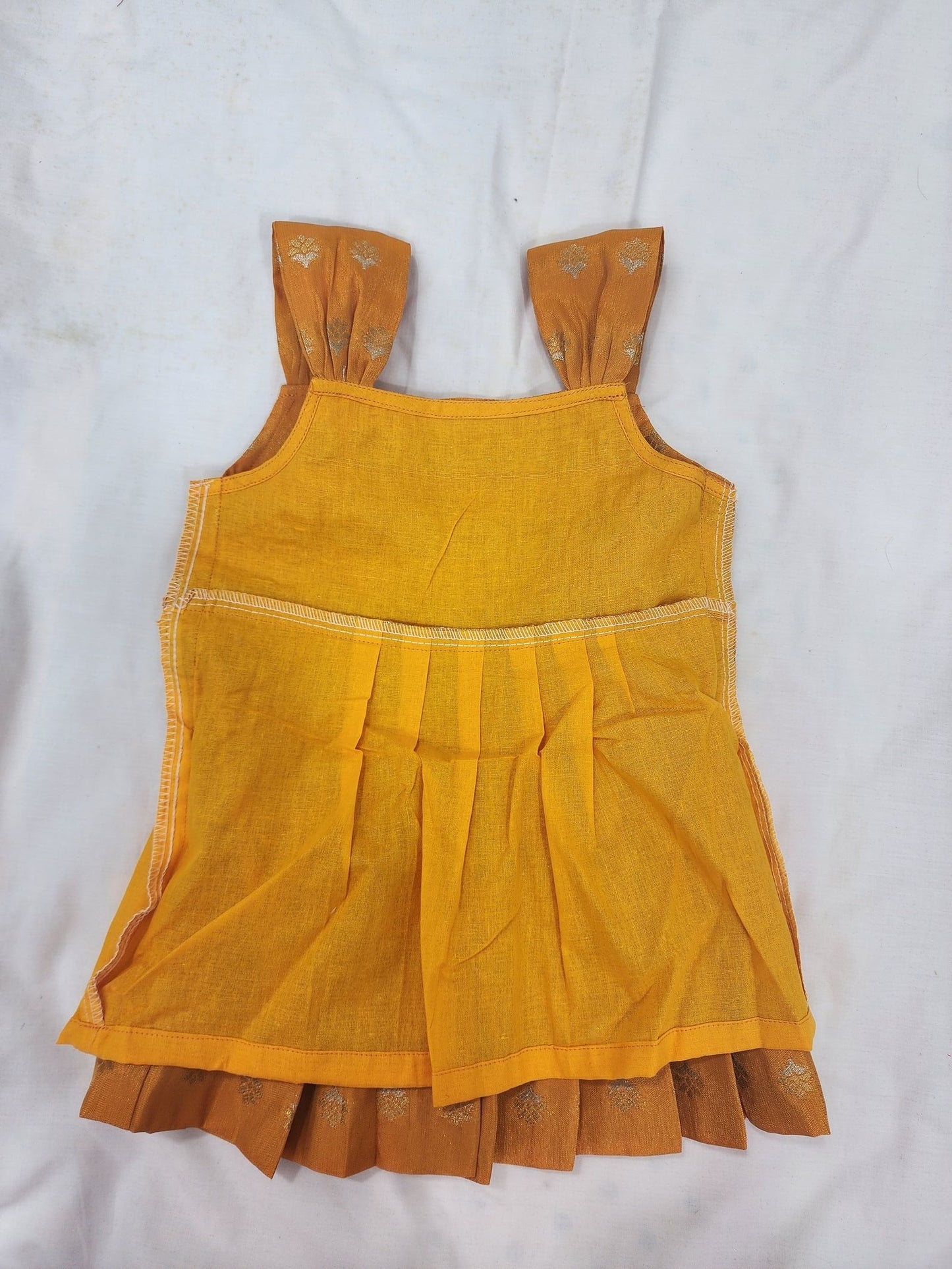 Yellow dress with ruffled hem on a white background