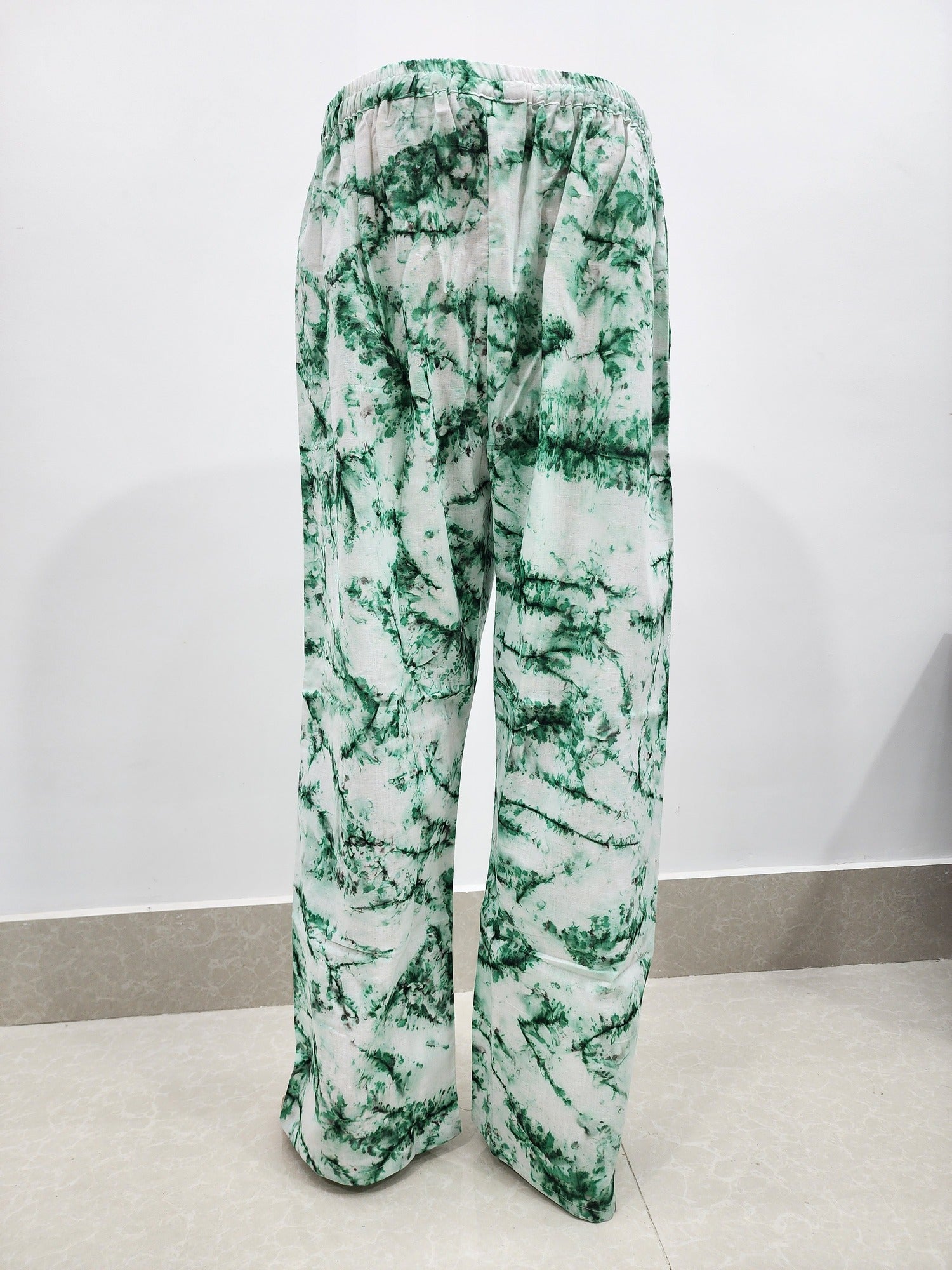 Green and white patterned pants on a white background