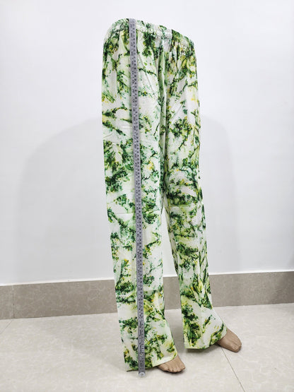 Green and white patterned pants with a measuring tape on a white background
