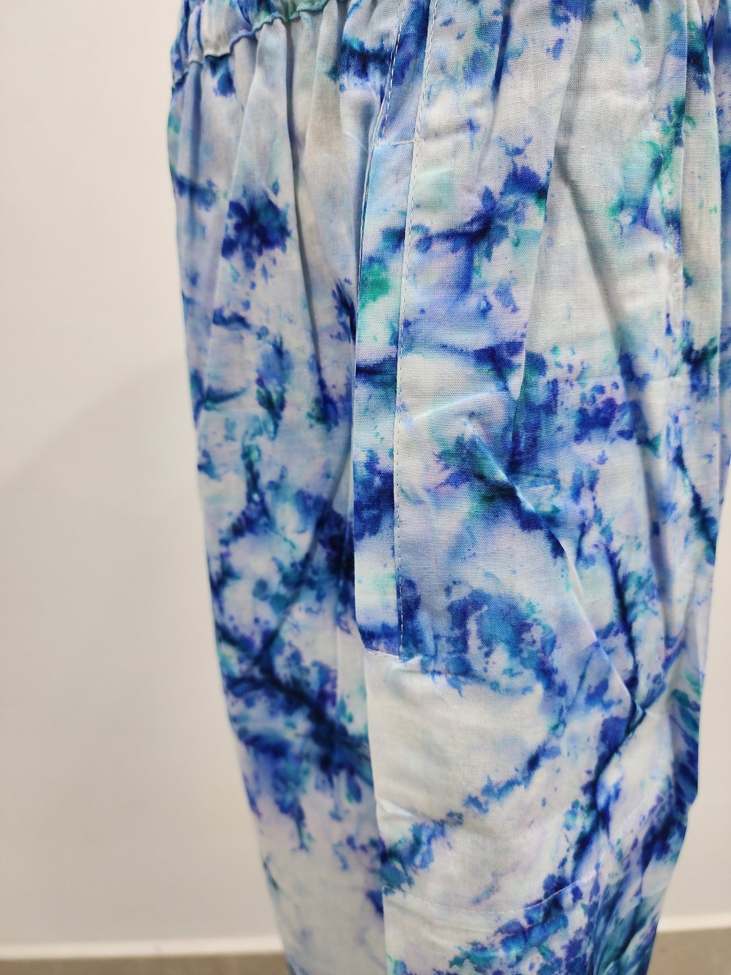 Blue and white tie-dye pants on a white background
