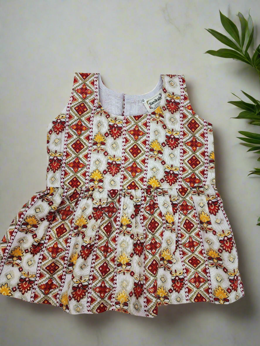 Children's dress with red, white, and yellow pattern on a light gray background