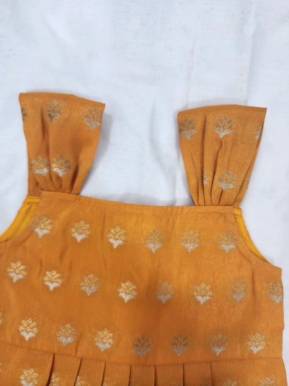 Yellow top with floral patterns on a white background
