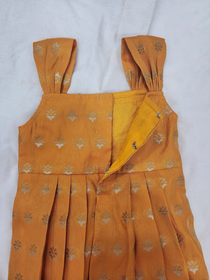 Mustard yellow dress with floral patterns on a white background