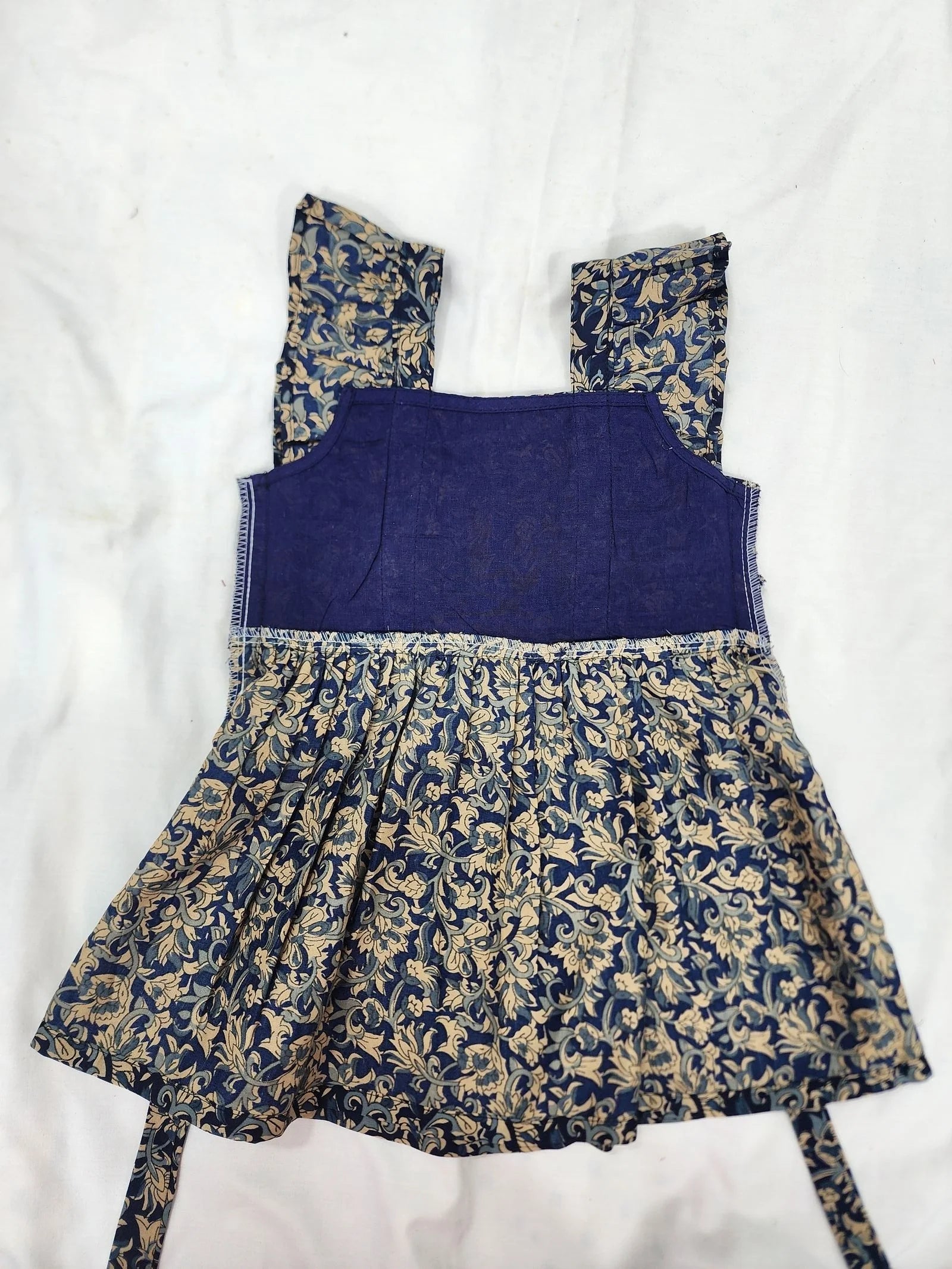 Blue dress with floral patterns on a white background