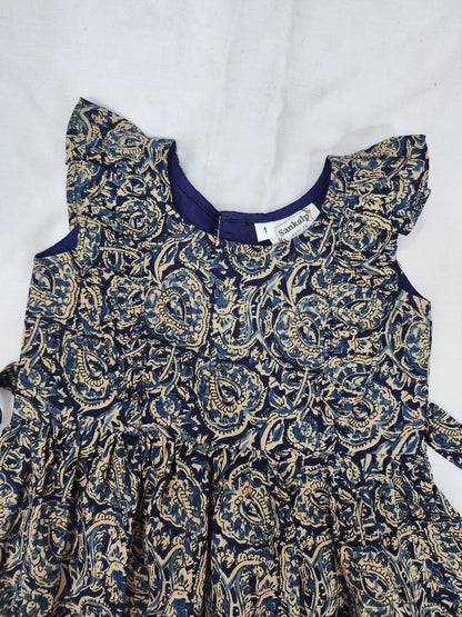 Children's dress with blue and gold paisley pattern on a white background