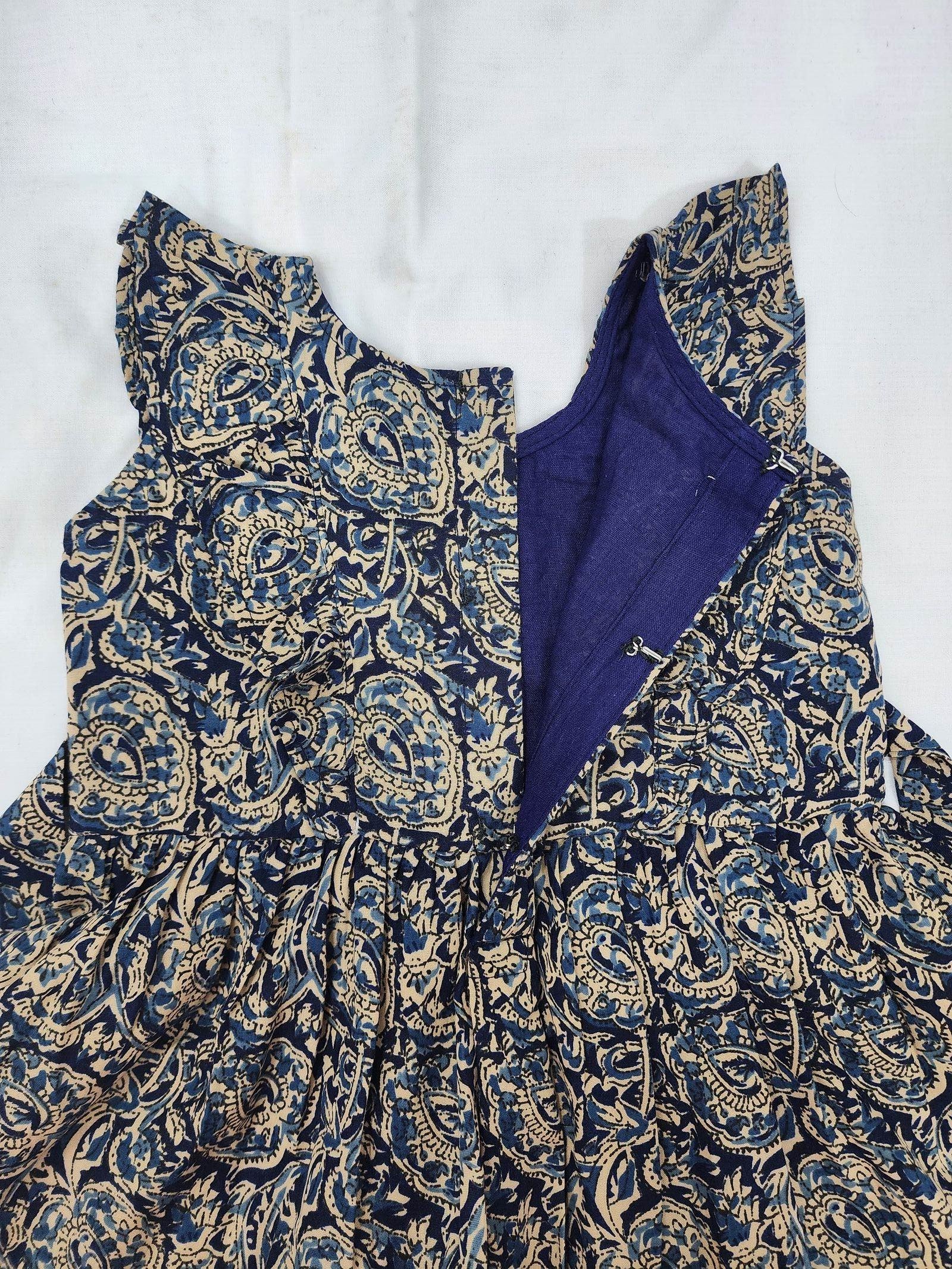 Blue and gold patterned garment on a white background